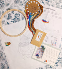 Load image into Gallery viewer, Kit contents: embroidery threads organized on a card, bamboo embroidery hoop, needle threader, magnetic needle minder (the orange flower!), preprinted 100% cotton fabric, instruction sheet - with link to online support content for more details on how to stitch everything as well as a recommended stitching order, and a thank you card!
